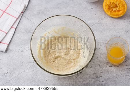 Glass Bowl With Egg-butter Mixture, Freshly Squeezed Orange Juice On A Gray Background. Cooking Gree