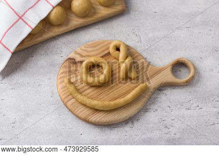 Raw Dough Pieces For Greek Easter Cookies With Sesame Seeds On A Gray Textured Background. Step By S