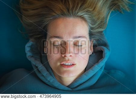 Vilnius, Lithuania - March 26 2023: Portrait Of A Beautiful Blond Caucasian Girl With A Blue Sweatsh