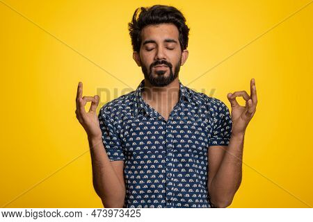 Keep Calm Down, Relax, Inner Balance. Young Indian Man Breathes Deeply With Mudra Gesture, Eyes Clos