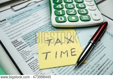 Text  Tax Time With Memo Empty Tax Forms 1040 With Pen Calculator On Desk