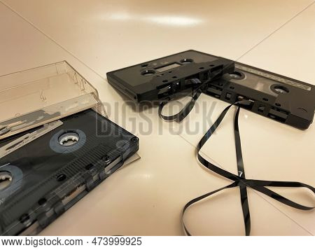 Different Cassette Tapes With Broken Tape Laying Around Ready To Rewound