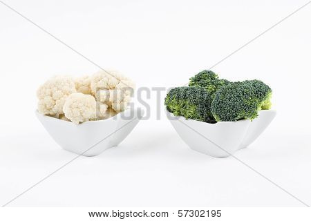 Fresh broccoli and cauliflower in a porcelain bowls
