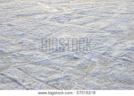 Skate marks on the surface of an outdoor ice rink