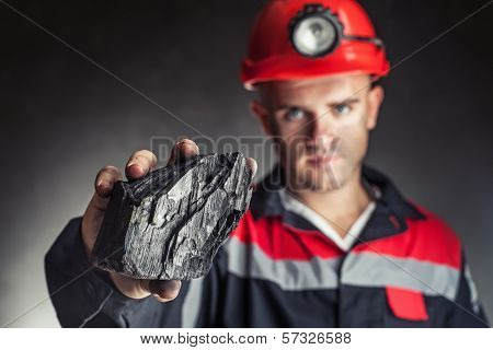 Coalminer Showing Lump Of Coal