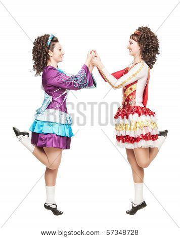 Two Young Women In Irish Dance Dresses Dancing Isolated