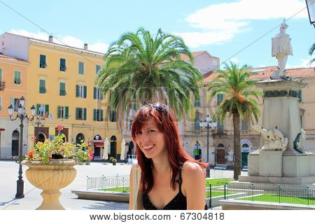 Beautiful smiling girl on a Piazza d'Italia in Sassari, Italy