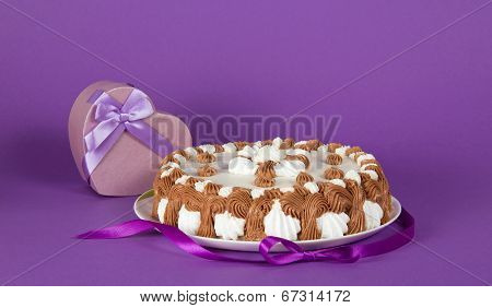 Gateau on dish decorated with tape and souvenir