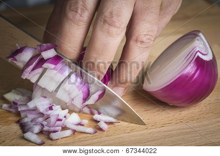 Chef Choppig A Red Onion With A Knife