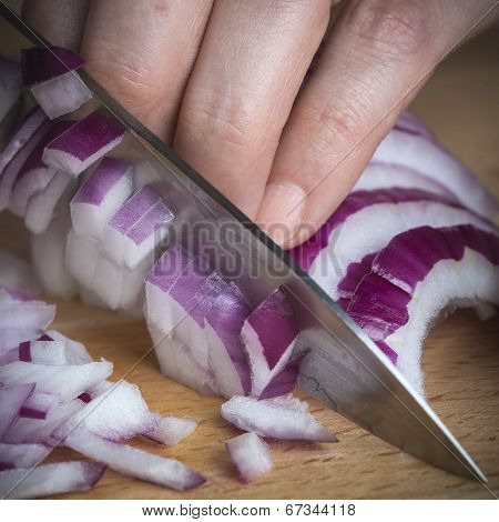Chef Choppig A Red Onion With A Knife