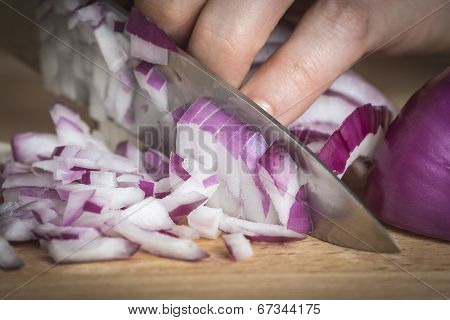 Chef Choppig A Red Onion With A Knife