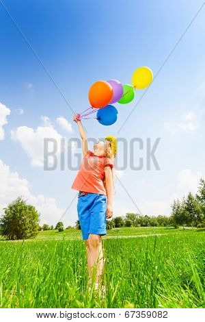 Girl with colorful balloons wears flower circlet