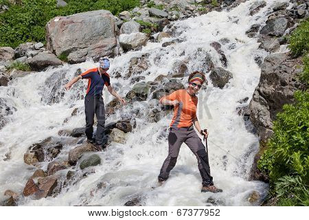 Trekkers Are Crossing Mountanious River In Zemo (upper) Svaneti, Caucasus, Georgia