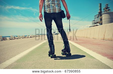 a young man roller skating, with a cross-processed effect