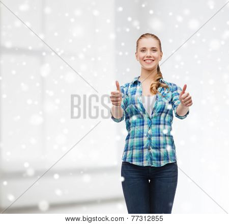 gesture, school and people concept - smiling student girl showing thumbs up over white room and snow background