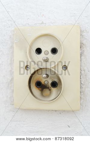 Old Burnt Plug In A Wall