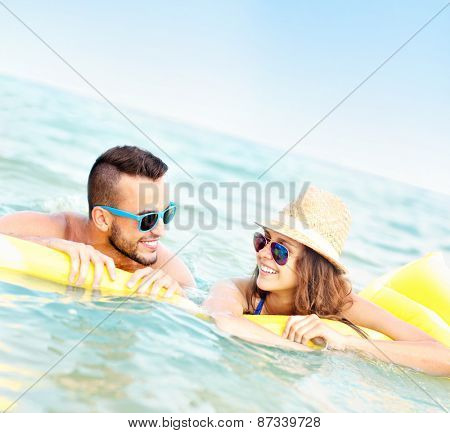 A picture of a young couple having fun on a matress in the Baltic Sea