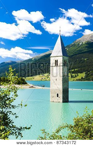 tower of sunken church in Resia lake, South Tyrol, Italy