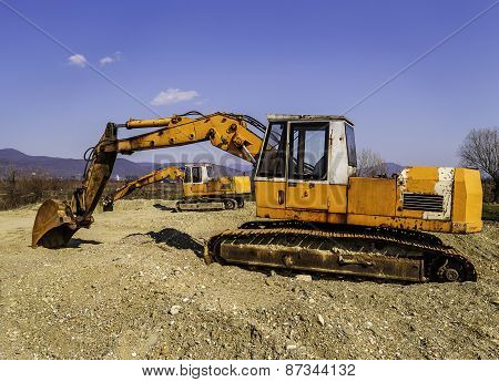 Old And Rusty Excavators Digging