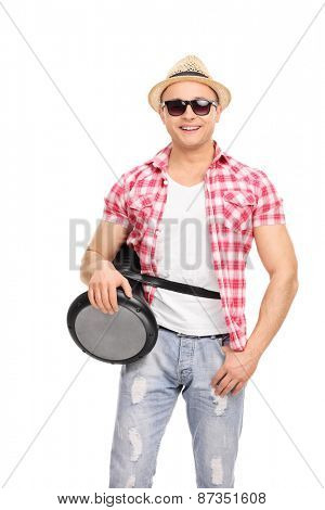 Vertical shot of a cool young musician with sunglasses holding a doumbek and looking at the camera isolated on white background