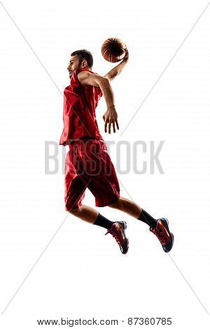 Isolated basketball player in action is flying high