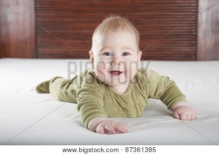 Green Onesie Baby Looking At Camera