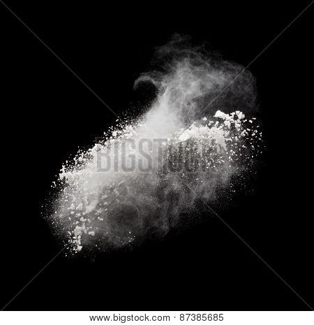 Freeze motion of white powder exploding, isolated on black. Abstract design of white dust cloud. Par