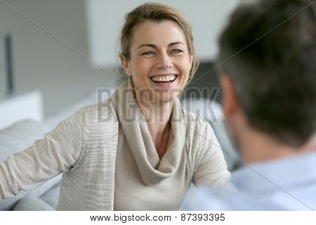 Couple at home sitting in sofa and having a talk