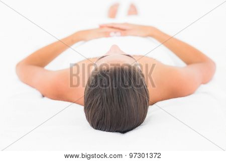 Breautiful young pretty woman on massage table with white background