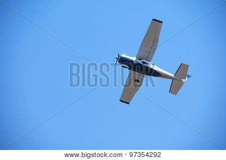 small retro airplane, clear blue sky in background