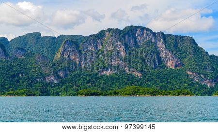 Beautiful Scene Blue Clear Water With Rock Mountain At Ratchaprapa Dam, Suratthani, Thailand