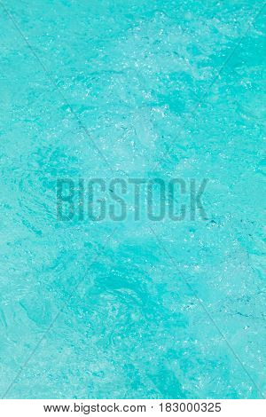 Clear background swimming pool rippled water detail.