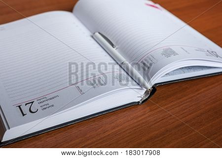 Black Diary, Or Sketchbook With Pen And Pencil On Th Table