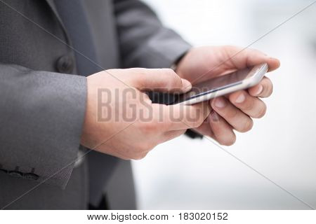 Business man holding device and touching screen