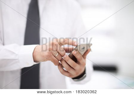 Mock up of a man holding device and touching screen of phone