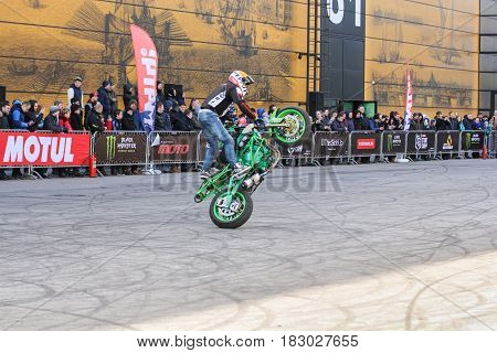 St. Petersburg Russia - 15 April, Doing the tricks on a motorcycle,15 April, 2017.
International Motor Show IMIS-2017 in Expoforurum.
Sports motorcycle show of bikers on the open area.