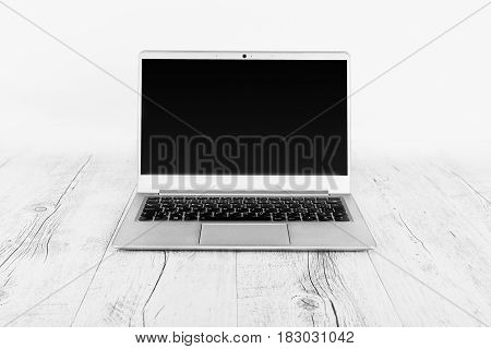 Ultra-thin notebook. The silver notebook on the desk the open notebook lies on a wooden background.