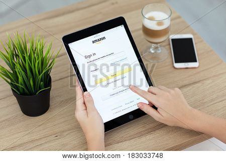 Alushta Russia - September 15 2016: Woman holding a iPad Pro with Online shopping service Amazon on the screen. iPad Pro 9.7 Space Gray was created and developed by the Apple inc.