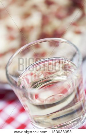 closeup of  a glass of white wine and flammkuchen