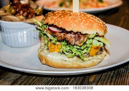 Sandwich hamburger with juicy burgers cheese and mix of vegetables