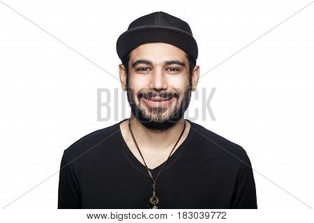 Portrait of young happy smilely man with black t-shirt and cap looking at camera with toothy smile. studio shot isolated on white background.