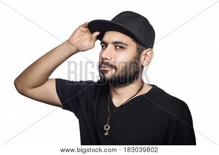 Portrait of young beautiful sexy man with black t-shirt and cap posing and looking at camera. studio shot isolated on white background.