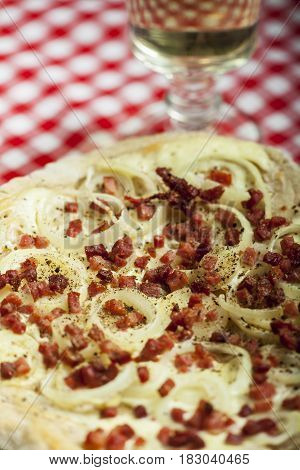 flammkuchen closeup with white wine in a glass
