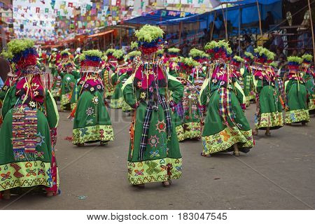 ORURO, BOLIVIA - FEBRUARY 26, 2017: Tinkus dancers in colourful costumes performing at the annual Oruro Carnival. The event is designated by UNESCO as being Intangible Cultural Heritage of Humanity.
