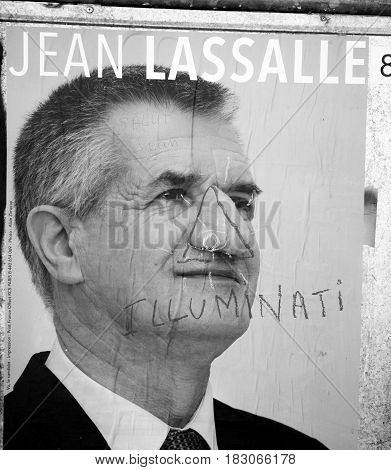 STRASBOURG FRANCE - APR 26 2017: Official campaign posters of Jean Lassalle political party leader of Resistons vandalized on the first round of 2017 French presidential election