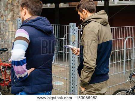 STRASBOURG FRANCE - APR 23 2017: Man waiting in queue to vote in the first round of the French presidential election in the city of Strasbourg France Alsace holding Carte Electorale