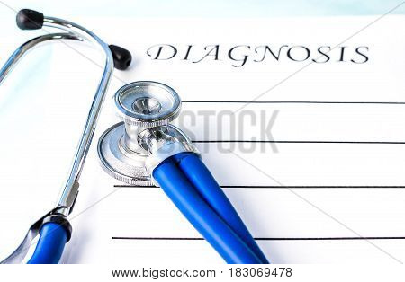 Attributes of the doctor's work are a phonendoscope (stethoscope) a form with the inscription "diagnosis". Focus on the phonendoscope membrane.