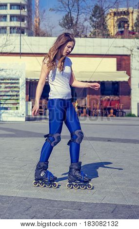 young Roller Girl is learning how to skate. First time on roller skates.