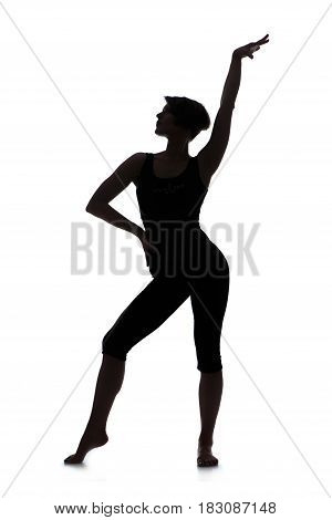 Silhouette of young woman dancer. Studio shot isolated on white background.