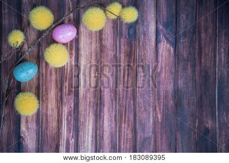 easter background with colored eggs yellow branches and copy space